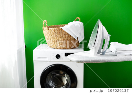 Laundry basket on washing machine in a laundry room Laundry basket on washing machine in a laundry room 107026137