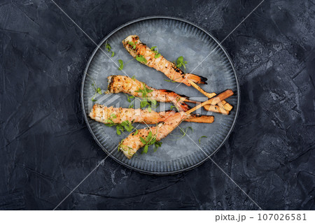 Grilled tiger shrimps, black background Grilled tiger shrimps, black background 107026581