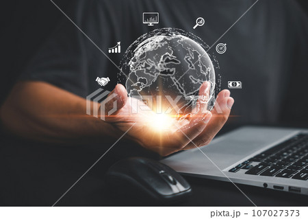 Business success in the global market. Man's hand holding virtual internet in the metaverse with laptop. Technology, digital marketing, and financial solutions. 107027373