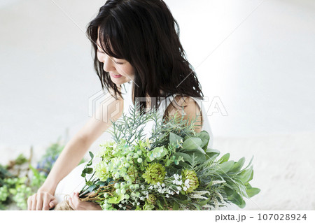 花束を持つ若い女性 107028924
