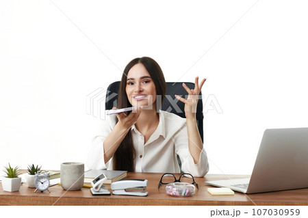 businesswoman working with laptop and having phone conversation businesswoman working with laptop and having phone conversation 107030959