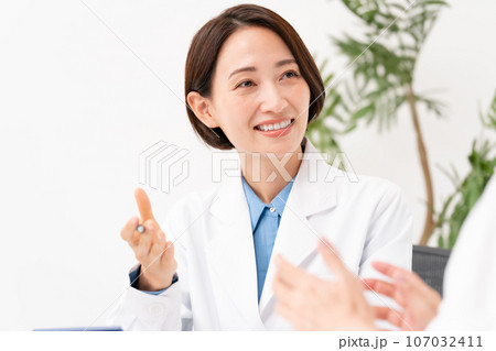対面で問診する医者と患者 対面で問診する医者と患者 107032411