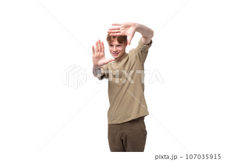 portrait of a handsome young caucasian man with red hair and a tattoo on his arm dressed in a khaki portrait of a handsome young caucasian man with red hair and a tattoo on his arm dressed in a khaki 107035915