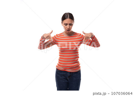 pretty young brunette woman dressed in tight orange sweater draws attention 107036064