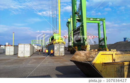 Container terminal. Sea port container terminal during work at night in fog Container terminal. Sea port container terminal during work at night in fog 107036427