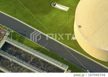 Aerial view of modern water cleaning facility at urban wastewater treatment plant. Purification process of removing undesirable chemicals, suspended solids and gases from contaminated liquid 107040748