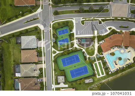 Aerial view of blue tennis courts for sports recreational activity Aerial view of blue tennis courts for sports recreational activity 107041031
