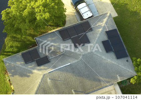 Aerial view building roof with rows of blue solar photovoltaic panels for producing clean ecological electric energy. Renewable electricity with zero emission concept 107041114
