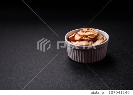 Delicious ripe red apple, sliced and dried in a special dryer 107041140