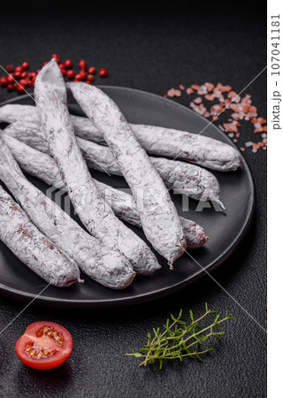 Delicious Spanish smoked sausage fuet with salt and spices Delicious Spanish smoked sausage fuet with salt and spices 107041181