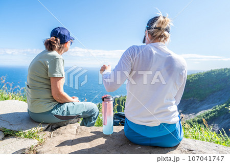 Unrecognizable woman enjoying view from mountains summer. Happy hiker traveler enjoy the view 107041747