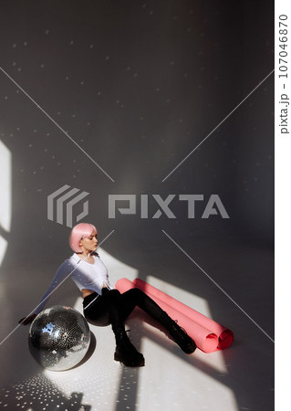 Contemporary Pink-Haired Woman in Minimalist Studio Contemporary Pink-Haired Woman in Minimalist Studio 107046870