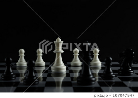 Pieces on chess board on black background for playing game and strategy. 107047947