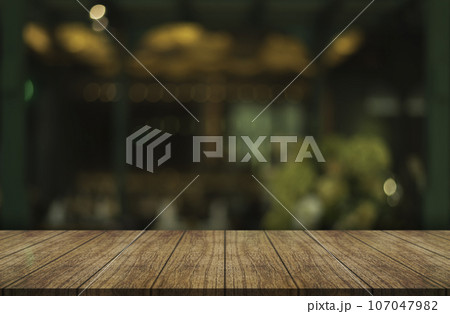 Empty wooden table top with lights bokeh on blur restaurant background. 107047982