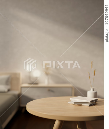 Copy space on a wooden round table in a cozy, minimalist bedroom. close-up image 107049942