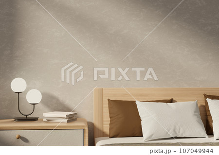 A cosy Scandinavia minimalist bedroom with a bed with comfy pillows and a bedside drawer. 107049944