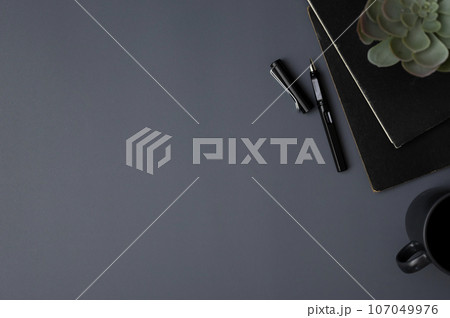 A modern office desk workspace with a copy space on grey background. top view A modern office desk workspace with a copy space on grey background. top view 107049976