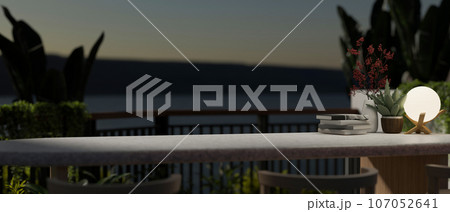 Copy space on a tabletop on a balcony with tropical plants and a beautiful nature view at night. 107052641