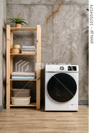 Washing machine in a gray modern laundry room Washing machine in a gray modern laundry room 107054574