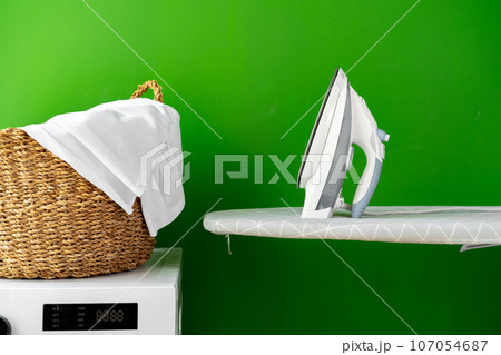 Laundry basket on washing machine in a laundry room 107054687