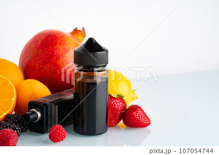 Vape and smoking liquid with fruit flavor on white background Vape and smoking liquid with fruit flavor on white background 107054744