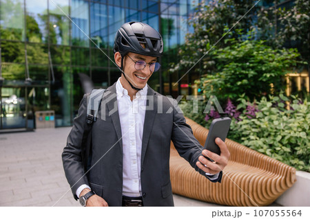 Young man in elegant suit and hemlet making selfie Young man in elegant suit and hemlet making selfie 107055564
