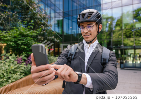 Young man in elegant suit and hemlet making selfie Young man in elegant suit and hemlet making selfie 107055565