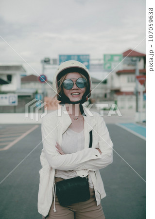 woman wearing safety helmet standing on city road toothy smile with happiness face 107059638
