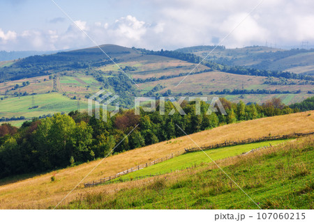 rural field on the steep hill. mountainous countryside scenery in early autumn. cloudy weather rural field on the steep hill. mountainous countryside scenery in early autumn. cloudy weather 107060215