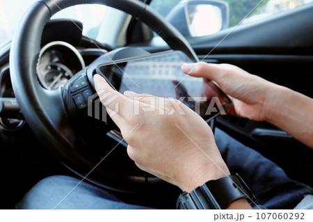 business man Sitting in the Car and Using digital tablet. business man Sitting in the Car and Using digital tablet. 107060292