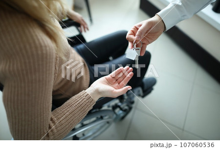Woman in wheelchair is given keys to house 107060536