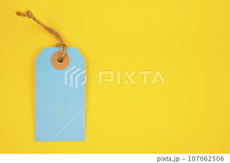 Blue color blank price tag on yellow background. Great for use as a price tag, gift tag, sale tag. 107062506