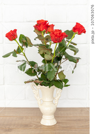 Beautiful bouquet of red roses in a ceramic vase. Beautiful bouquet of red roses in a ceramic vase. 107063076