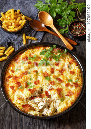 fusilli pasta bacon cheese chicken bake, top view fusilli pasta bacon cheese chicken bake, top view 107063100
