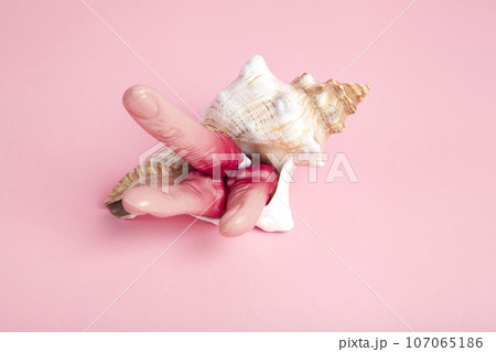 Fingers snatched from a corpse emerging from a conch shell 107065186