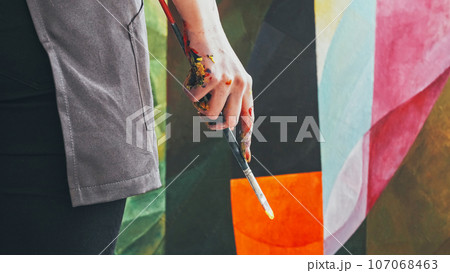Abstract painting. Modern masterpiece. Contemporary painter woman artist hand with paintbrush in colorful acrylic paint drawing artwork at art studio. 107068463