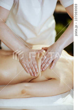 Closeup on medical massage therapist do therapeutic massage 107069069