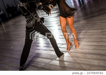 a couple dance a Latin dance. the legs of a dancing couple 107069592