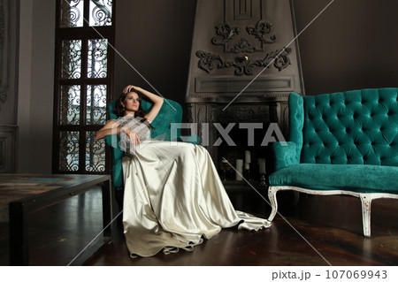 Gorgeous nice woman fashion model sitting in luxurious interior 107069943