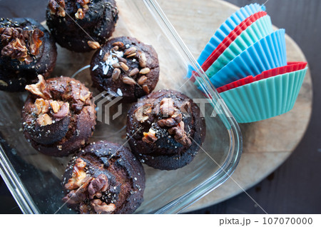 Freshly baked muffins , Cupcake molds . Homemade baking concept, top view. Freshly baked muffins , Cupcake molds . Homemade baking concept, top view. 107070000