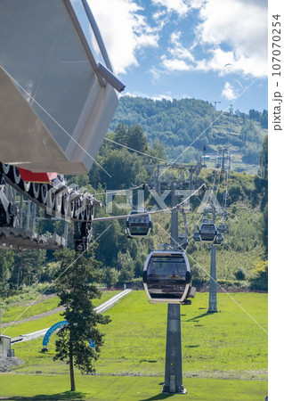 19.08.2023, Manzherok resort, Russia. Close-up of a cable car cabin against the sky. Cable car trip to viewpoints in the mountains. During the trip by cable car Tourists enjoy beautiful views  107070254