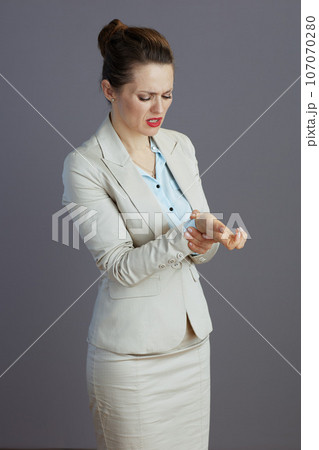 sad trendy small business owner woman in light business suit 107070280