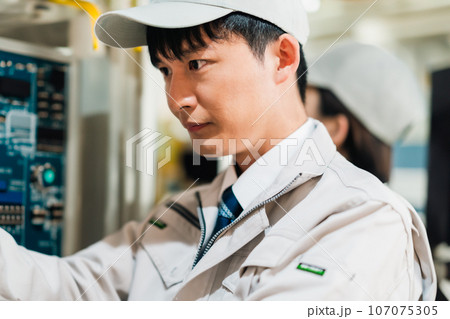 工場の製造設備をメンテナンスをする男性エンジニア 工場の製造設備をメンテナンスをする男性エンジニア 107075305