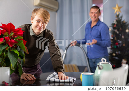 Schoolboy with father cleaning in house before New Year 107076659
