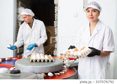 Woman holding carton tray with fresh eggs on farm Woman holding carton tray with fresh eggs on farm 107076792
