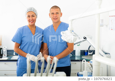 Portrait of successful dentist and his nurse assistant in clinic office Portrait of successful dentist and his nurse assistant in clinic office 107076821
