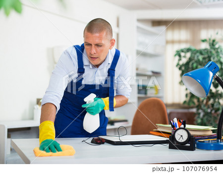 Skillful worker of cleaning service wiping furniture in office Skillful worker of cleaning service wiping furniture in office 107076954