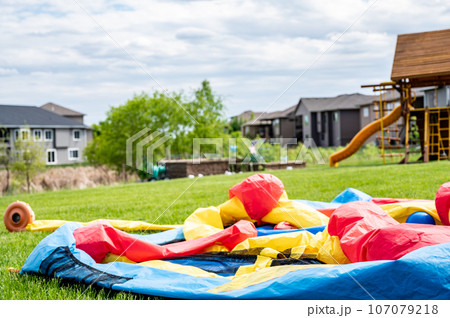 Deflated bouncy house in backyard 107079218