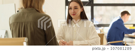 Business woman talking to client and making notes on documents in office. 107081289