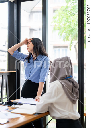 An unhappy Asian female boss, feeling tired of her unprofessional employee An unhappy Asian female boss, feeling tired of her unprofessional employee 107082765